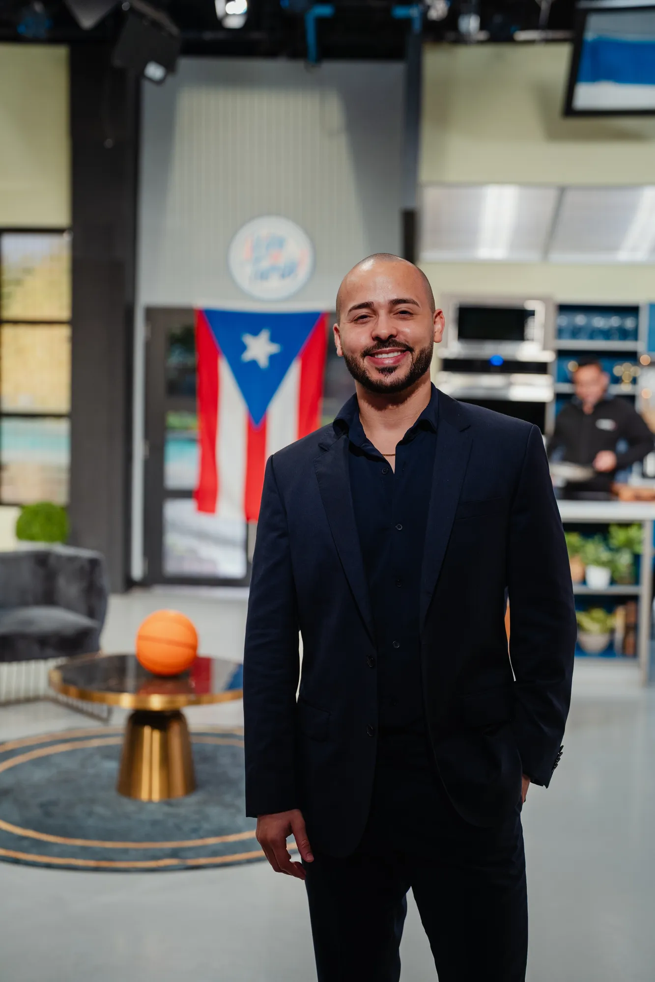 Gabriel on a TV set, with the Puerto Rico flag behind him